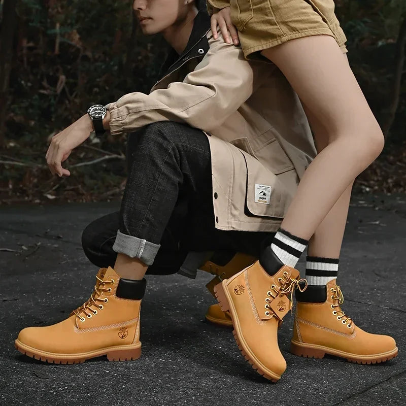 Botas altas de cuero para hombre y mujer, zapatos de alta calidad, zapatillas de deporte para exteriores, botines antideslizantes con cordones para pareja