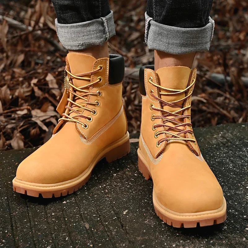 Botas altas de cuero para hombre y mujer, zapatos de alta calidad, zapatillas de deporte para exteriores, botines antideslizantes con cordones para pareja