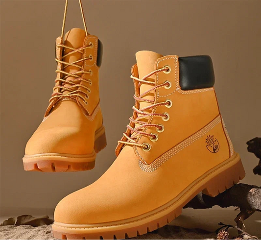 Botas altas de cuero para hombre y mujer, zapatos de alta calidad, zapatillas de deporte para exteriores, botines antideslizantes con cordones para pareja