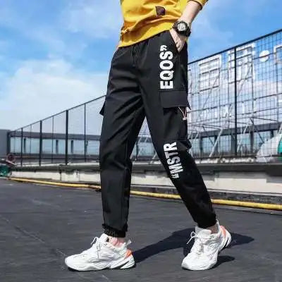 Pantalones deportivos holgados con múltiples bolsillos para primavera y verano, estilo urbano para hombre, con cordón en la cintura, pantalones cargo para fitness al aire libre.