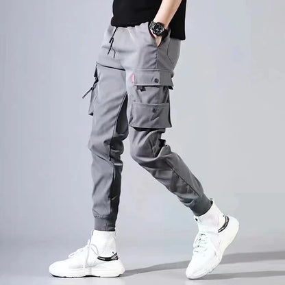 Pantalones deportivos holgados con múltiples bolsillos para primavera y verano, estilo urbano para hombre, con cordón en la cintura, pantalones cargo para fitness al aire libre.