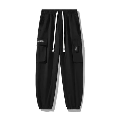 Pantalones deportivos holgados con múltiples bolsillos para primavera y verano, estilo urbano para hombre, con cordón en la cintura, pantalones cargo para fitness al aire libre.